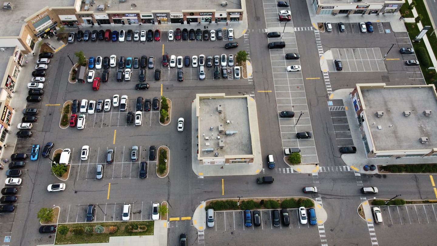 Closer aerial view of Ridgeway Plaza storefronts and the parking areas between them