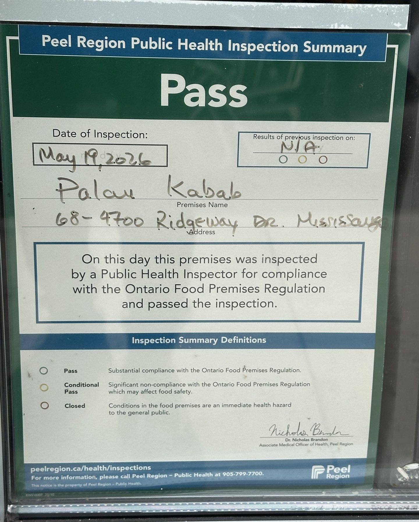 Peel Region Public Health Inspection Summary notice reading Pass, dated May 19, 2026, premises name Palau Kabab, address 68 - 4700 Ridgeway Dr, Mississauga, with the previous inspection marked N/A