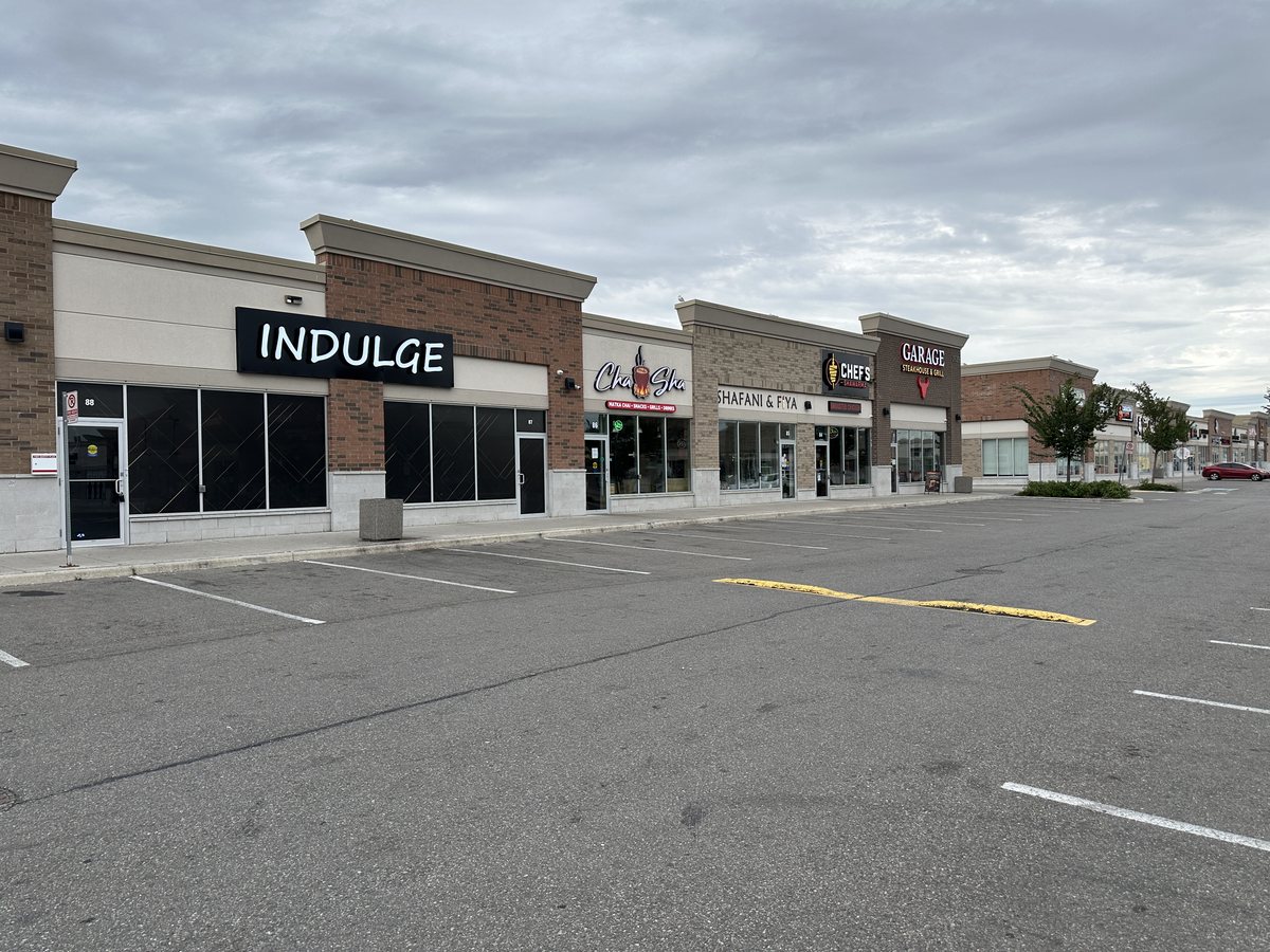 The Indulge, Cha Sha, Chef’s Shawarma and Garage Steakhouse storefront row at Ridgeway Plaza in September 2026