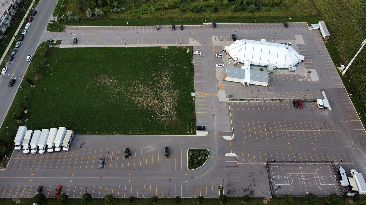 Aerial view of the Muslim Neighbour Nexus mosque site on Odyssey Drive, showing its own parking area next to the Ridgeway Plaza cluster