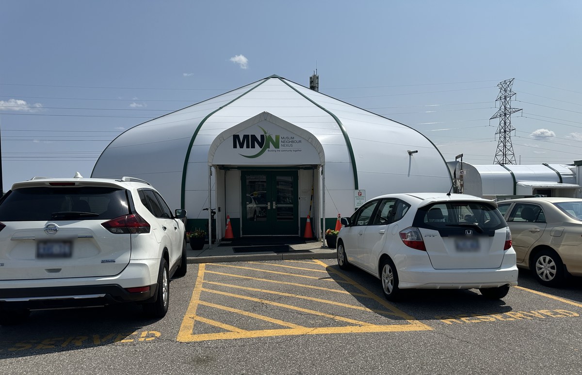 The Muslim Neighbour Nexus mosque entrance on Odyssey Drive beside Ridgeway Plaza, a white domed structure with the MNN sign above the doors